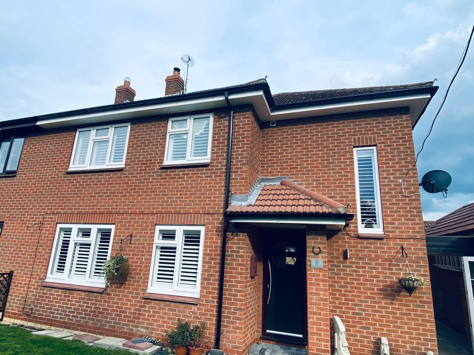 UK brick house with white uPVC fascias