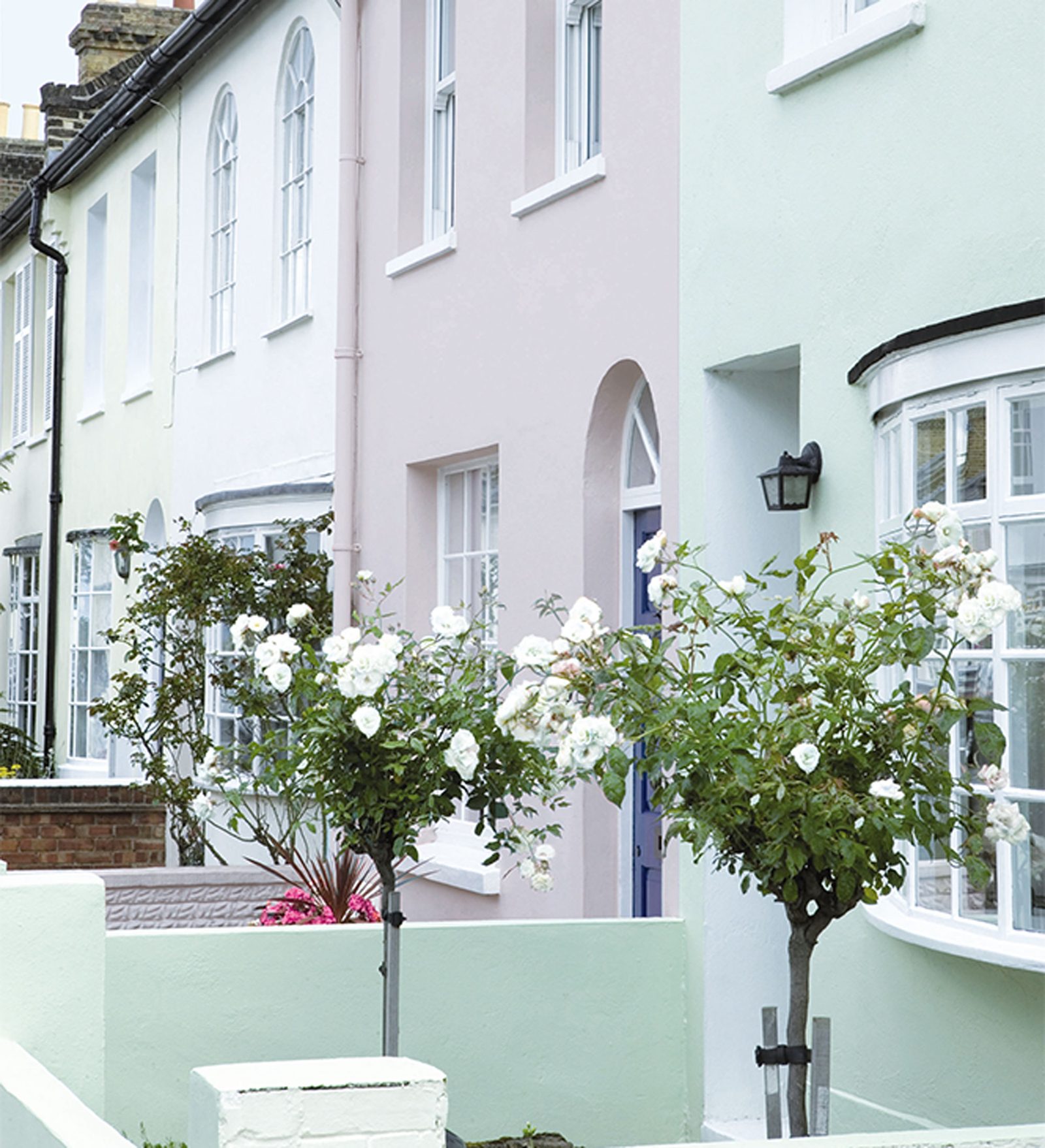 Decorator painting an exterior wall